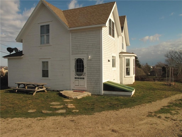 540 Off Center Rd, Block Island, RI 02807 - back of property featuring roof with shingles and a lawn