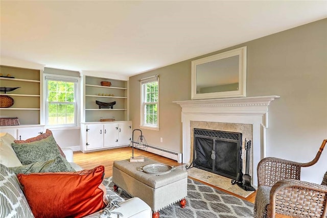 15 Lafayette Rd, Barrington, RI 02806 - living room with baseboard heating, light wood-type flooring, plenty of natural light, and a fireplace with flush hearth