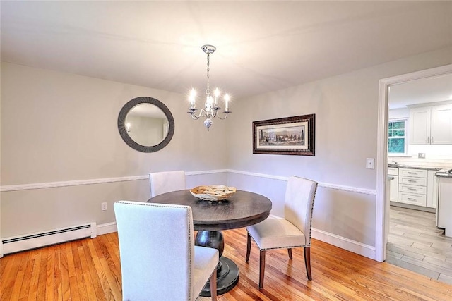 15 Lafayette Rd, Barrington, RI 02806 - dining area with a baseboard radiator, light wood-style flooring, a chandelier, and baseboards