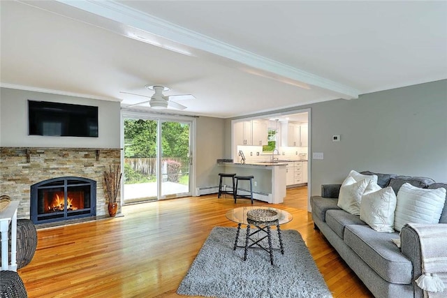 15 Lafayette Rd, Barrington, RI 02806 - living room with light wood-style floors, crown molding, a stone fireplace, ceiling fan, and beamed ceiling