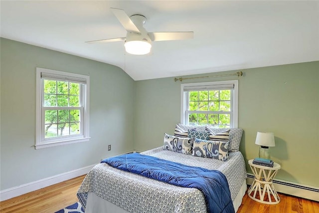 15 Lafayette Rd, Barrington, RI 02806 - bedroom featuring multiple windows, vaulted ceiling, a baseboard heating unit, baseboards, and wood finished floors