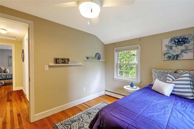 15 Lafayette Rd, Barrington, RI 02806 - bedroom featuring a baseboard heating unit, wood finished floors, baseboards, vaulted ceiling, and a ceiling fan