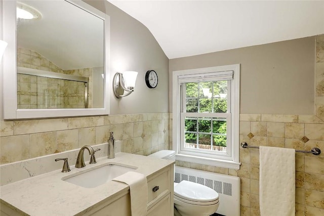 15 Lafayette Rd, Barrington, RI 02806 - full bathroom with radiator heating unit, tile walls, vaulted ceiling, vanity, and toilet