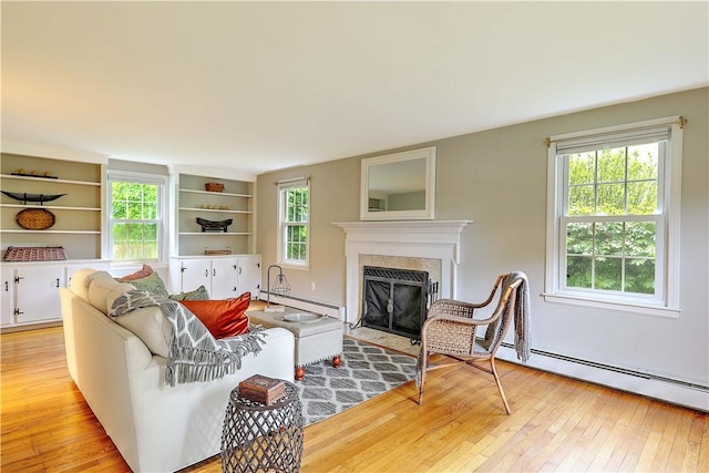 15 Lafayette Rd, Barrington, RI 02806 - living room with baseboard heating, healthy amount of natural light, light wood-type flooring, and a fireplace