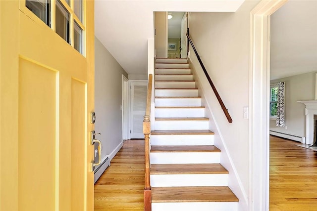 15 Lafayette Rd, Barrington, RI 02806 - stairs with a baseboard radiator, wood finished floors, and baseboards