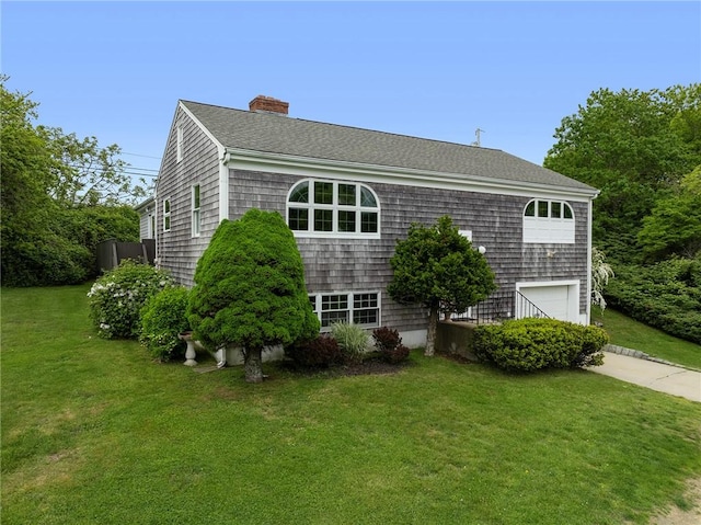 3 Ernest St, Newport, RI 02840 - view of side of property featuring a garage, a yard, a chimney, driveway, and roof with shingles