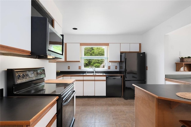 3 Ernest St, Newport, RI 02840 - kitchen featuring black appliances, a sink, dark countertops, and white cabinetry