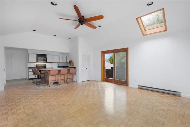 3 Ernest St, Newport, RI 02840 - living area featuring a baseboard heating unit, a skylight, a ceiling fan, baseboards, and high vaulted ceiling