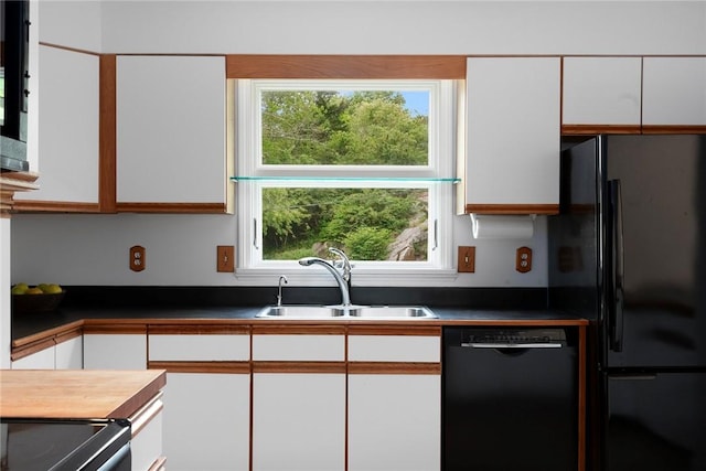 3 Ernest St, Newport, RI 02840 - kitchen with black appliances, a sink, white cabinetry, and dark countertops