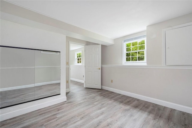 3 Ernest St, Newport, RI 02840 - unfurnished bedroom with wood finished floors, baseboards, and a closet