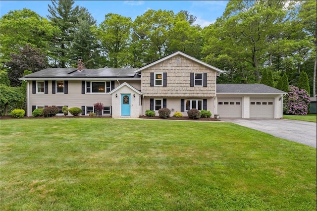19 Bruce Dr, North Smithfield, RI 02896 - tri-level home featuring an attached garage, asphalt driveway, a front lawn, and roof mounted solar panels