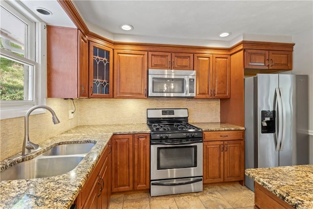 19 Bruce Dr, North Smithfield, RI 02896 - kitchen with appliances with stainless steel finishes, a sink, light stone countertops, glass insert cabinets, and backsplash