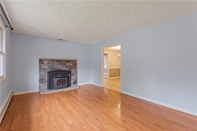 19 Bruce Dr, North Smithfield, RI 02896 - unfurnished living room featuring a baseboard radiator, wood finished floors, baseboards, and healthy amount of natural light