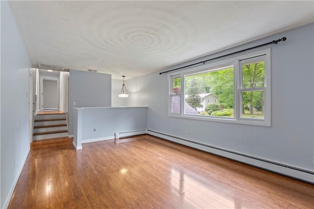 19 Bruce Dr, North Smithfield, RI 02896 - spare room with hardwood / wood-style flooring, baseboard heating, baseboards, and a baseboard heating unit