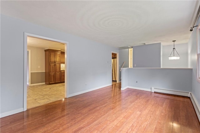 19 Bruce Dr, North Smithfield, RI 02896 - unfurnished room with a baseboard radiator, light wood-style flooring, and baseboards