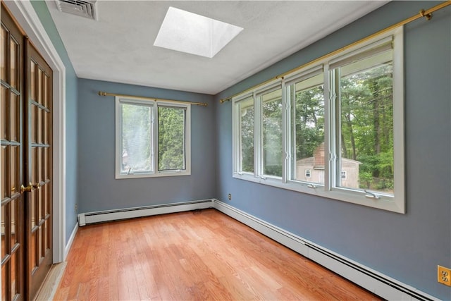 19 Bruce Dr, North Smithfield, RI 02896 - empty room featuring a skylight, a baseboard radiator, light wood-style flooring, and baseboards