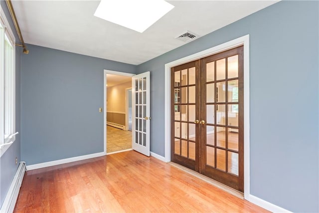 19 Bruce Dr, North Smithfield, RI 02896 - spare room with french doors, a baseboard radiator, baseboards, and wood finished floors
