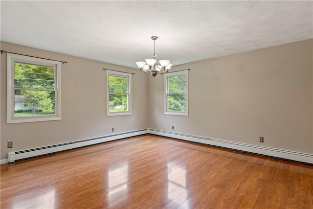 19 Bruce Dr, North Smithfield, RI 02896 - unfurnished room featuring a chandelier, baseboard heating, wood finished floors, and baseboards