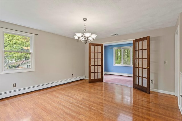 19 Bruce Dr, North Smithfield, RI 02896 - empty room featuring french doors, baseboard heating, a baseboard radiator, and healthy amount of natural light