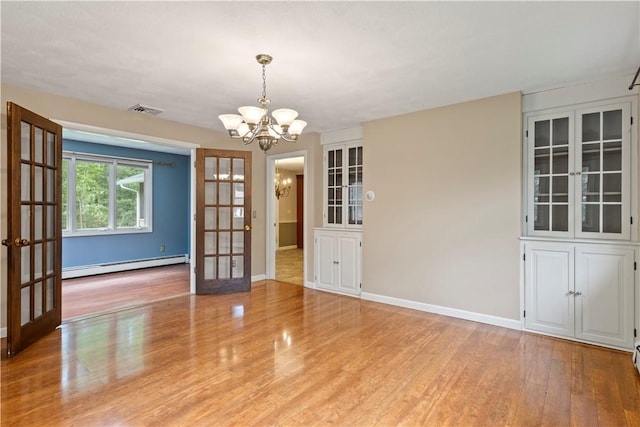 19 Bruce Dr, North Smithfield, RI 02896 - unfurnished room featuring a baseboard radiator, a chandelier, french doors, and wood finished floors