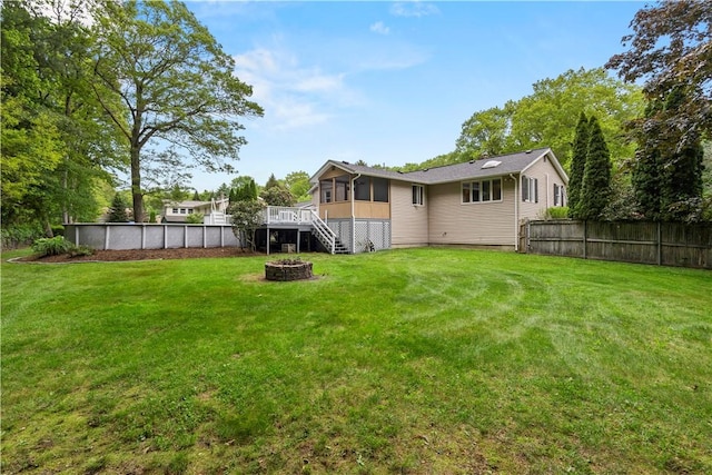 19 Bruce Dr, North Smithfield, RI 02896 - view of yard with an outdoor fire pit, a sunroom, stairs, and a wooden deck