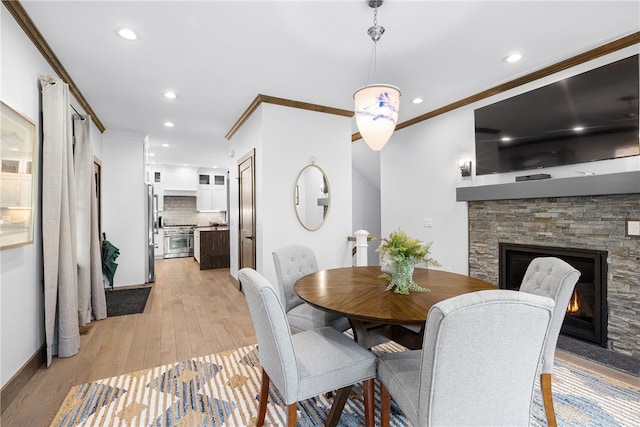 3 Gardenia Dr Unit M6, Richmond, RI 02898 - dining area featuring ornamental molding, light wood-type flooring, recessed lighting, a stone fireplace, and baseboards