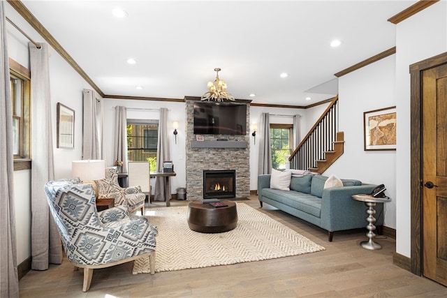 3 Gardenia Dr Unit M6, Richmond, RI 02898 - living room with ornamental molding, a stone fireplace, baseboards, wood finished floors, and a chandelier