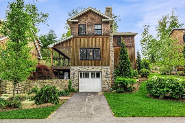 3 Gardenia Dr Unit M6, Richmond, RI 02898 - view of front of house featuring a garage, driveway, a chimney, stone siding, and a balcony