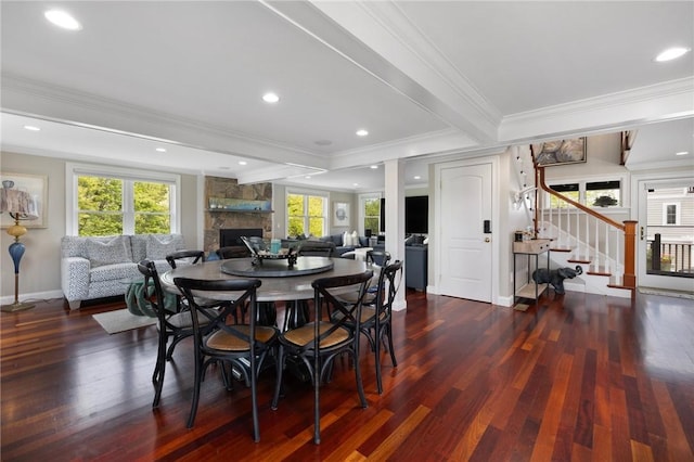 129 Sand Hill Cove Rd, Narragansett, RI 02882 - dining area featuring a stone fireplace, wood finished floors, crown molding, stairway, and baseboards