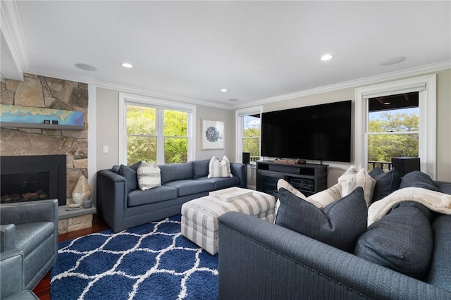 129 Sand Hill Cove Rd, Narragansett, RI 02882 - living room with ornamental molding, plenty of natural light, wood finished floors, recessed lighting, and a stone fireplace
