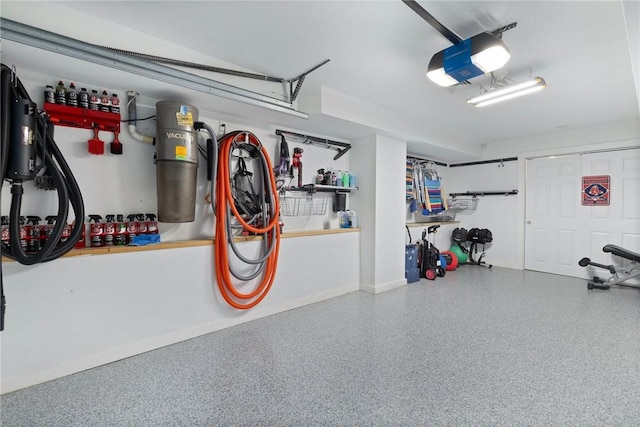129 Sand Hill Cove Rd, Narragansett, RI 02882 - garage featuring a garage door opener, a central vacuum unit, and baseboards