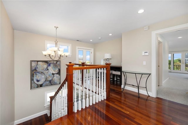 129 Sand Hill Cove Rd, Narragansett, RI 02882 - stairs featuring a chandelier, wood finished floors, baseboards, and recessed lighting