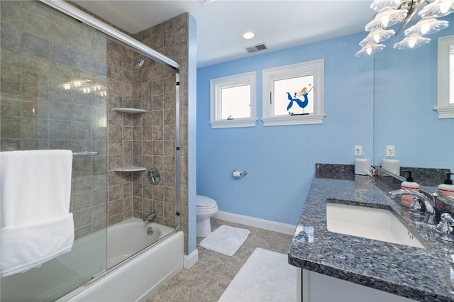 129 Sand Hill Cove Rd, Narragansett, RI 02882 - bathroom with double vanity, toilet, bath / shower combo with glass door, baseboards, and a chandelier