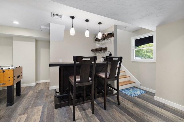 129 Sand Hill Cove Rd, Narragansett, RI 02882 - indoor bar featuring dark wood finished floors, baseboards, hanging light fixtures, and recessed lighting