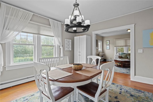 47 Cliff St, East Greenwich, RI 02818 - dining space with a chandelier, wood finished floors, a baseboard radiator, baseboards, and baseboard heating