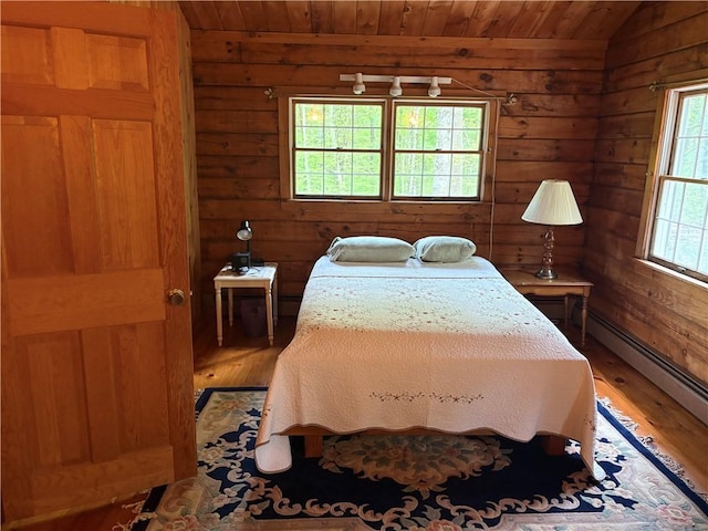 85 Plainfield Pike, Foster, RI 02825 - bedroom with a baseboard radiator, wooden ceiling, light wood-type flooring, wooden walls, and lofted ceiling