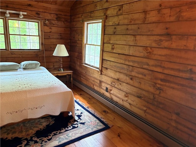 85 Plainfield Pike, Foster, RI 02825 - bedroom with hardwood / wood-style flooring, wood walls, and baseboard heating