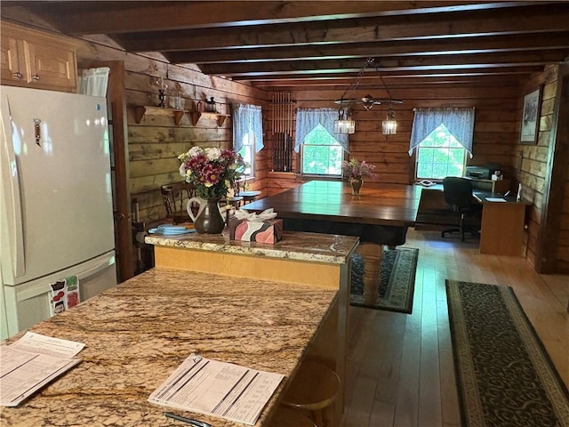 85 Plainfield Pike, Foster, RI 02825 - kitchen with freestanding refrigerator, wooden walls, hardwood / wood-style floors, beamed ceiling, and pendant lighting