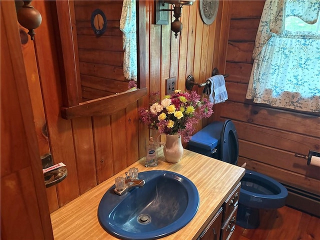 85 Plainfield Pike, Foster, RI 02825 - bathroom with toilet, wooden walls, vanity, and wood finished floors