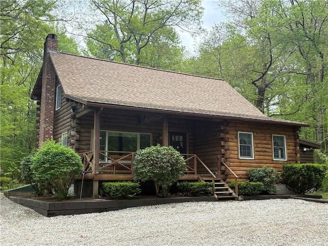 85 Plainfield Pike, Foster, RI 02825 - log-style house with log exterior, covered porch, a chimney, and roof with shingles