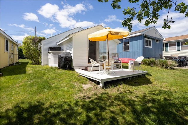 64 Burnside Ave, Narragansett, RI 02882 - rear view of house featuring a wooden deck and a lawn