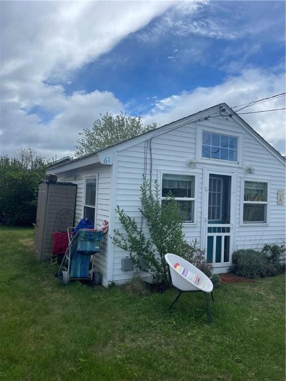 64 Burnside Ave, Narragansett, RI 02882 - rear view of house featuring a lawn