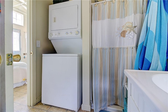 64 Burnside Ave, Narragansett, RI 02882 - laundry room featuring stacked washing machine and dryer and light tile patterned floors