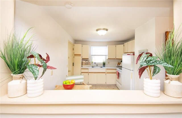 70 Carroll Ave Unit 510, Newport, RI 02840 - kitchen featuring white appliances, a sink, light countertops, and cream cabinets
