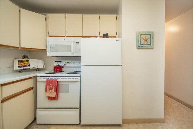 70 Carroll Ave Unit 510, Newport, RI 02840 - kitchen with white appliances, light countertops, and baseboards