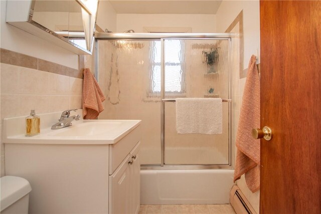 70 Carroll Ave Unit 510, Newport, RI 02840 - full bath with vanity, toilet, combined bath / shower with glass door, baseboard heating, and plenty of natural light