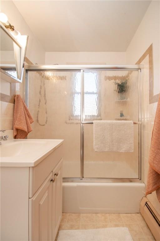 70 Carroll Ave Unit 510, Newport, RI 02840 - bathroom featuring a baseboard radiator, enclosed tub / shower combo, vanity, and tile patterned flooring