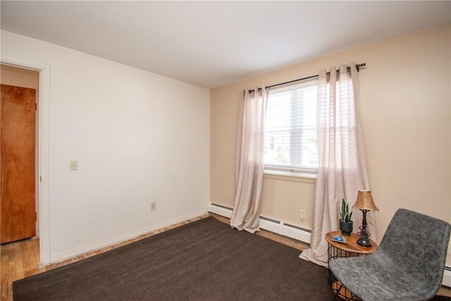 70 Carroll Ave Unit 510, Newport, RI 02840 - unfurnished room with wood finished floors, a baseboard heating unit, and baseboards