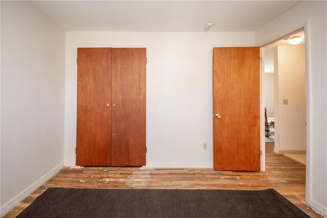 70 Carroll Ave Unit 510, Newport, RI 02840 - unfurnished bedroom with wood finished floors and baseboards