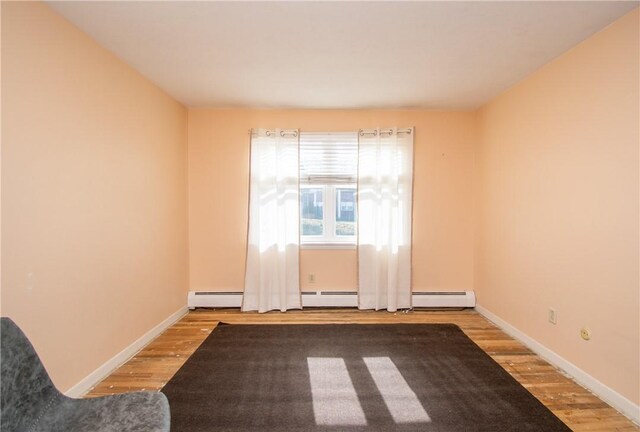 70 Carroll Ave Unit 510, Newport, RI 02840 - unfurnished room with wood finished floors, baseboards, and baseboard heating